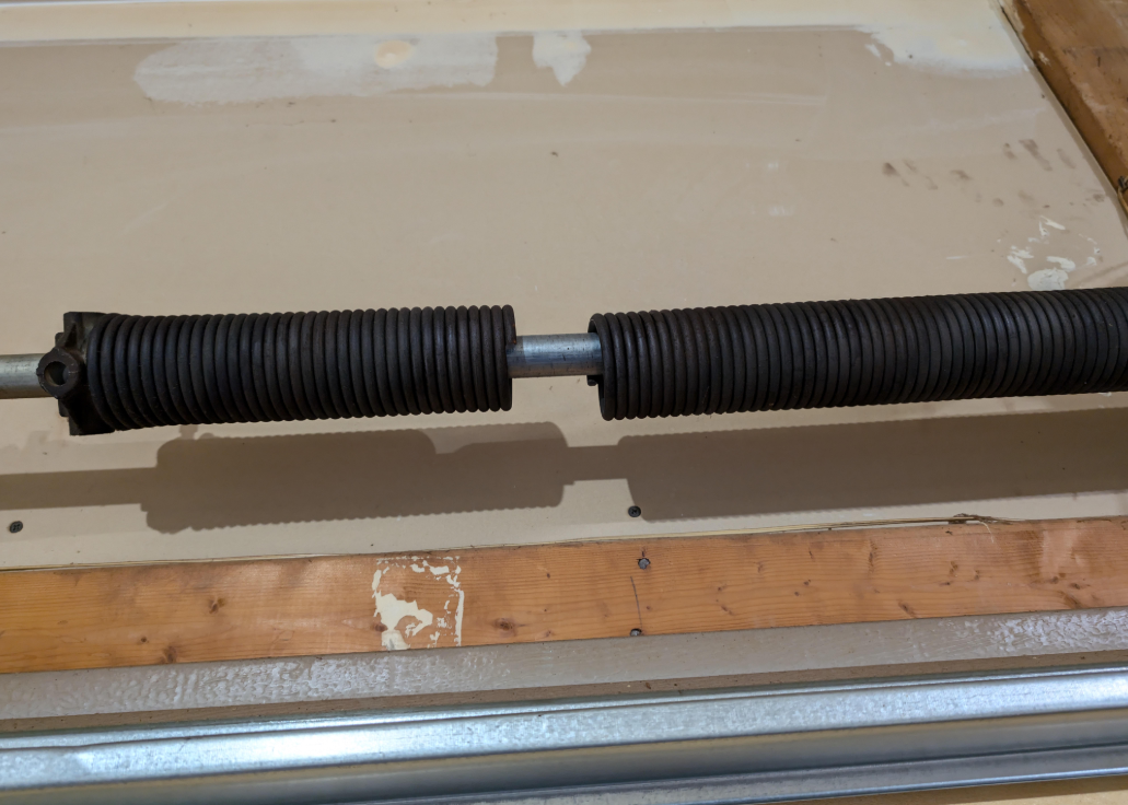 Professional Garage Door Technician working on a spring in Pembroke Pines
